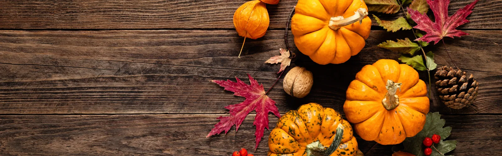 pumpkins sitting on top of a wooden table